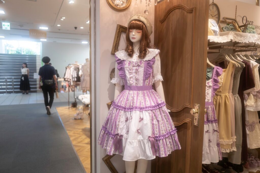 Explore Harajuku fashion in Japan, featuring a mannequin in a colorful Lolita dress. Perfect for fashion-themed tours.