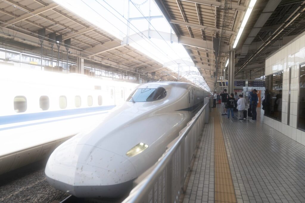 Japan bullet train at station platform, a must-see experience on guided Japan tours.