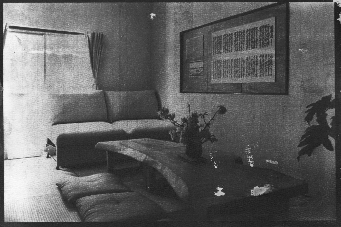 KAKU interior — ikebana and natural wood table, cyanotype print