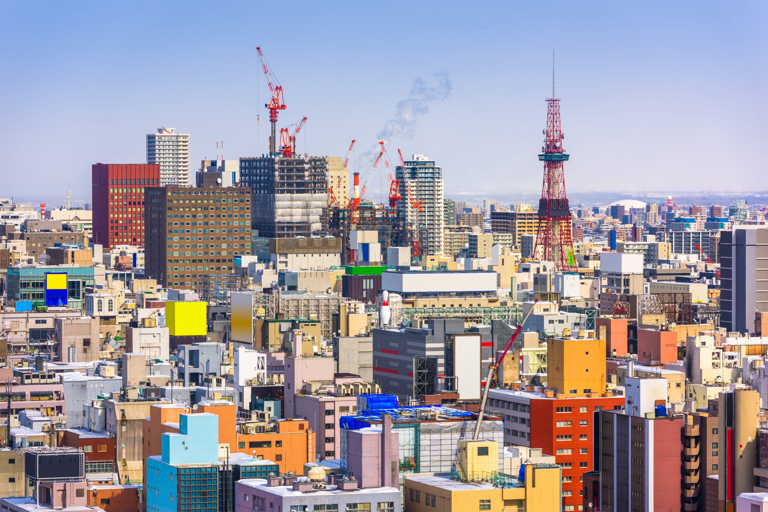 Vibrant Sapporo cityscape with construction cranes, ideal for exploring Japan's urban architecture and culture.