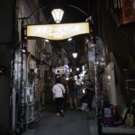 Nightlife in Tokyo's Golden Gai district, showcasing narrow alleys and vibrant lights on a Japan tour.
