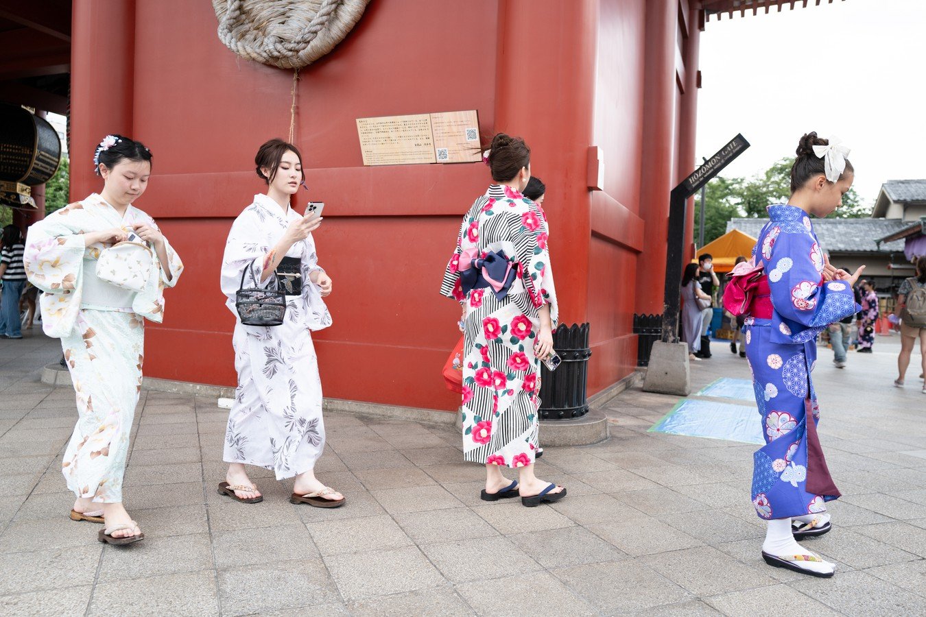 Women in colorful kimonos exploring a traditional Japanese temple, ideal for cultural Japan tours.