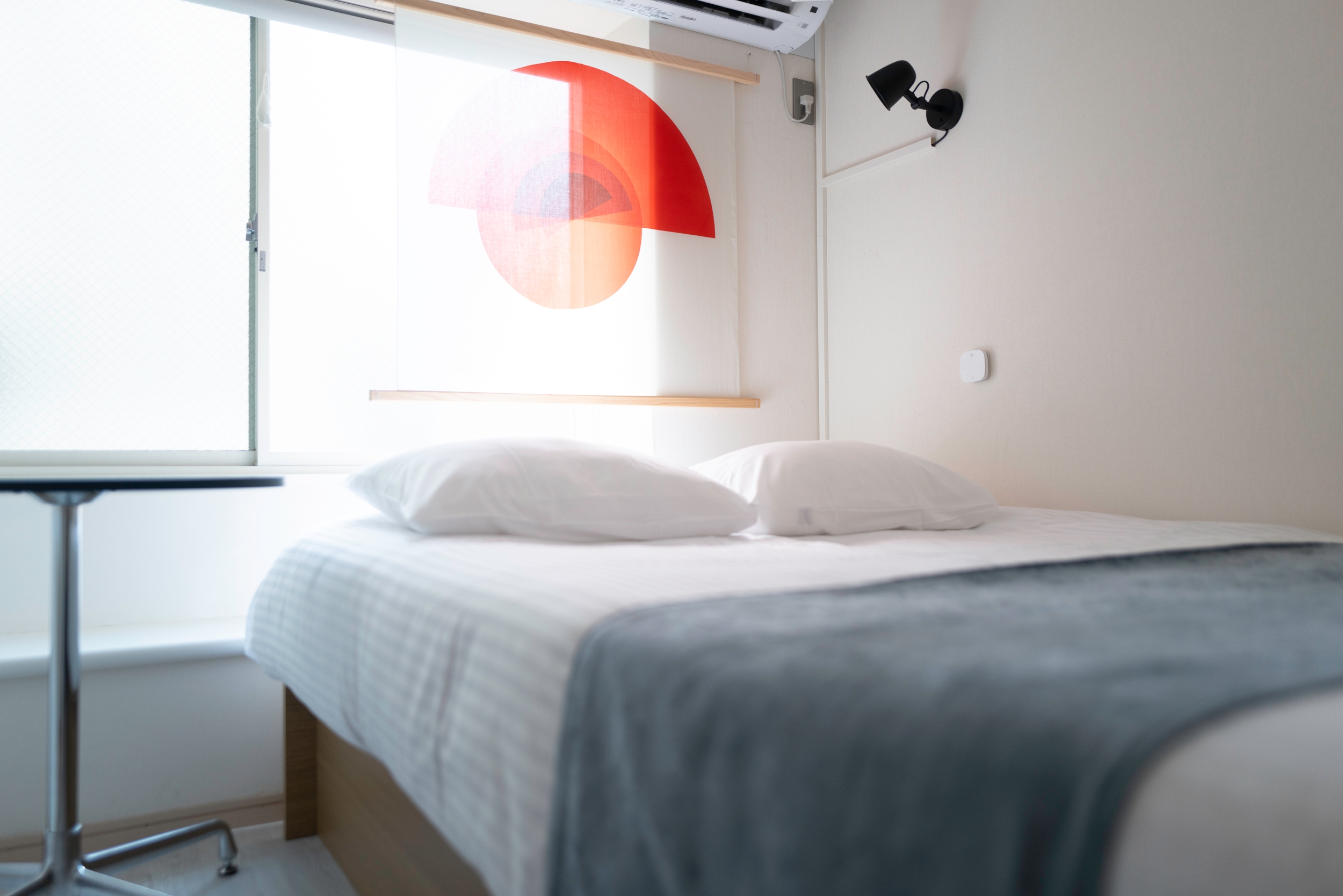 Modern Tokyo hotel room with cozy bed and art decor, ideal for Japan tour accommodations.