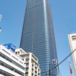 Modern skyscraper and Tokyo Tower on a clear day, ideal for Japan tour itineraries exploring urban landscapes.