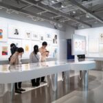 Visitors exploring a modern art gallery in Japan, highlighting contemporary exhibits during a cultural tour.