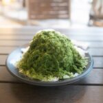 Matcha shaved ice dessert, a Japanese summer treat, enjoyed during Japan tours. Refreshing and unique culinary experience.