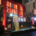 Vibrant night scene of a Japanese hotel with colorful decor and statues, perfect for Japan tour enthusiasts.