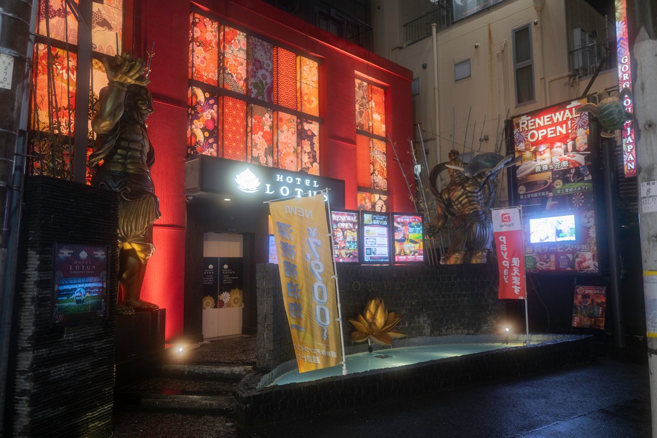 Vibrant night scene of a Japanese hotel with colorful decor and statues, perfect for Japan tour enthusiasts.