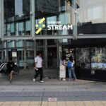 Visitors at Shibuya Stream entrance, Tokyo—a vibrant spot on Japan tours, perfect for dining and shopping.