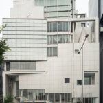 Modern architectural building in Tokyo, Japan on a cloudy day, showcasing urban design for tourists exploring Japan.