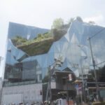 Harajuku, Japan modern architecture with glass facade and greenery, explore this unique Tokyo landmark on our Japan tours.