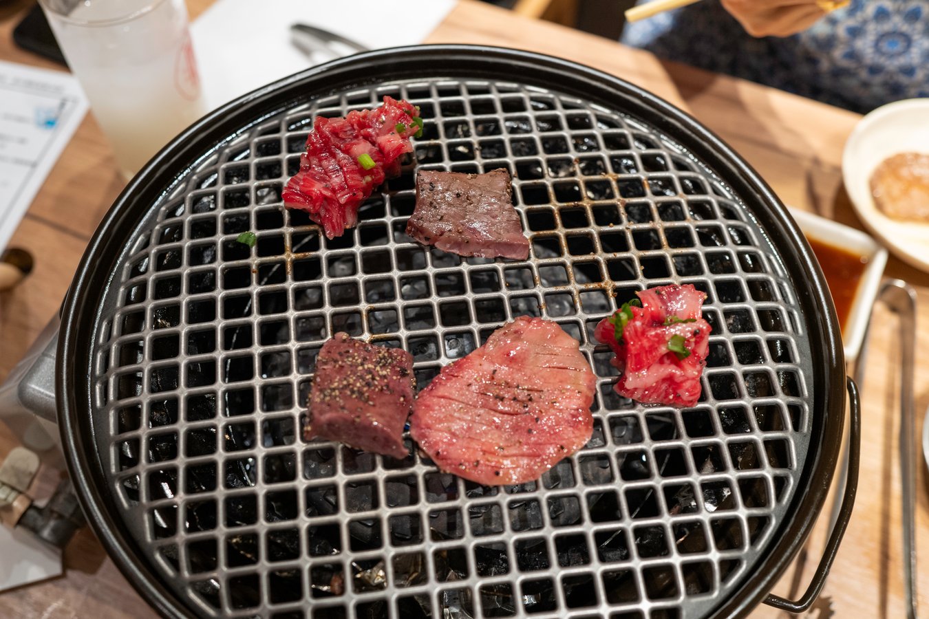 Grilling delicious Wagyu beef during a Japanese culinary tour experience. Perfect savory delight for food enthusiasts.