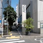 Modern street in Japan with urban architecture and greenery, perfect for exploring on a city tour.