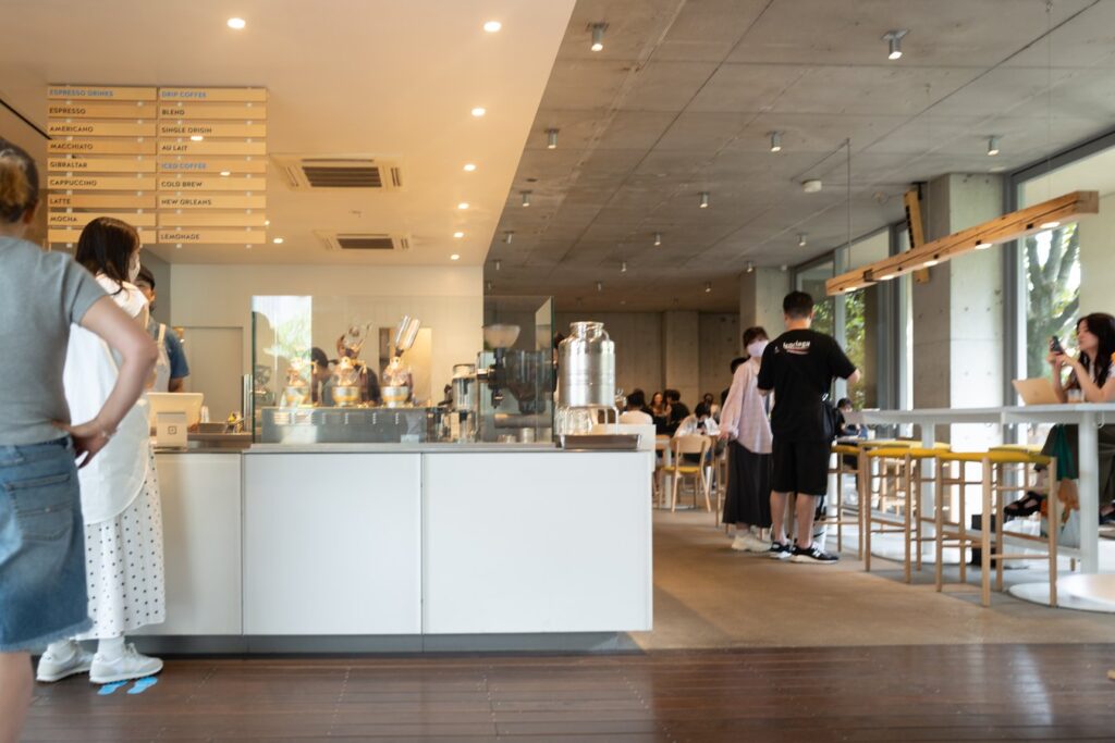 Modern Tokyo cafe interior with patrons enjoying coffee, ideal for Japan tour enthusiasts seeking authentic experiences.