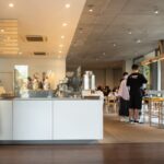 Modern Tokyo cafe interior with patrons enjoying coffee, ideal for Japan tour enthusiasts seeking authentic experiences.