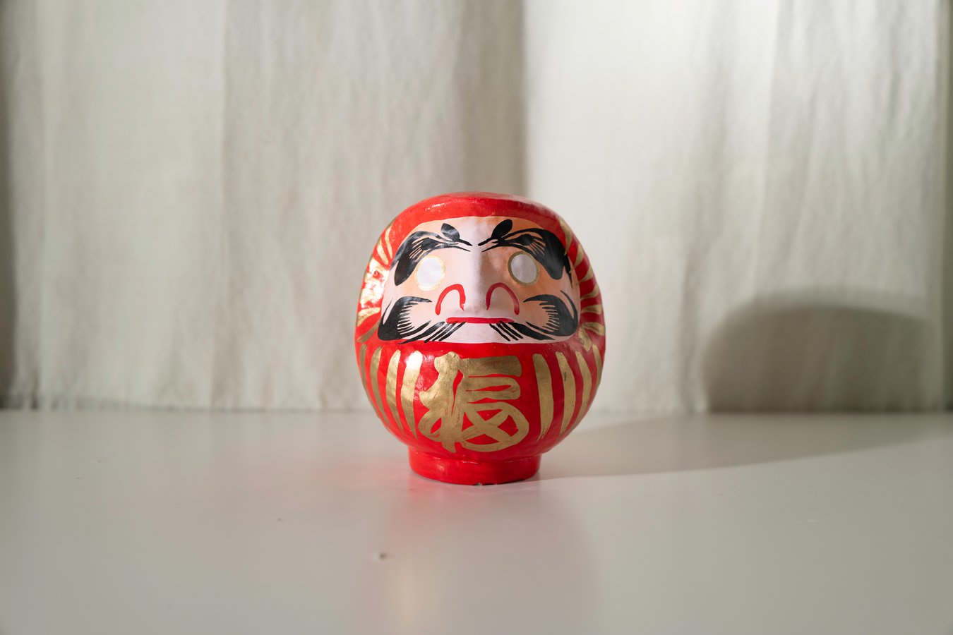 Daruma doll on display, symbolizing perseverance and luck, perfect for authentic Japan tour experiences.