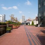 Modern architecture and scenic walkway in Tokyo, Japan on a sunny day—ideal for urban exploration tours.