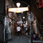 Nighttime stroll in a lively alley of Golden Gai, Shinjuku, Tokyo, Japan. Discover vibrant nightlife on Japan tours.