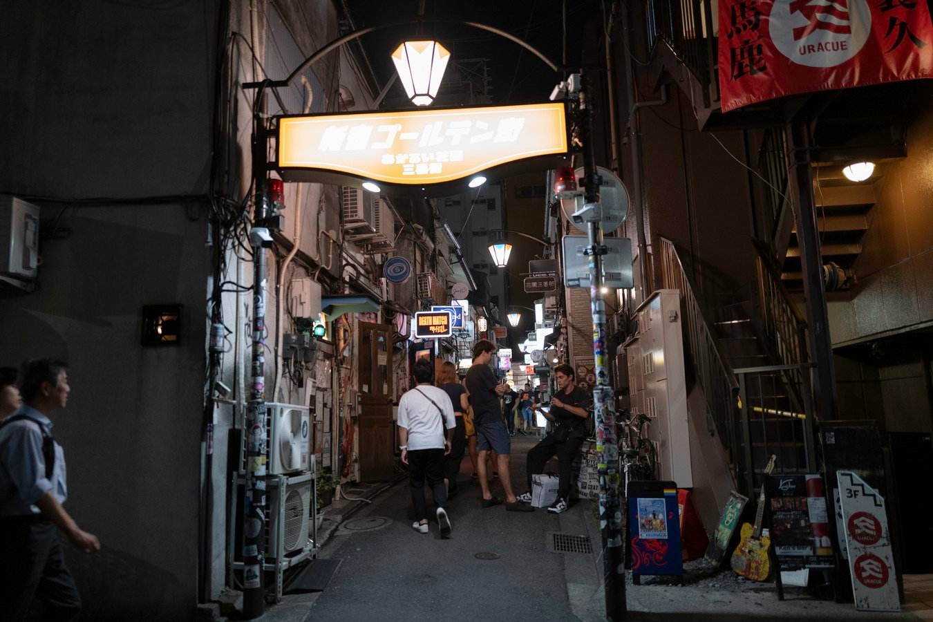 Nighttime stroll in a lively alley of Golden Gai, Shinjuku, Tokyo, Japan. Discover vibrant nightlife on Japan tours.