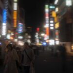 Nightlife in Tokyo's vibrant city streets, illuminated by neon signs, showcasing dynamic urban experiences on Japan tours.