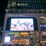 Night view of Tokyo's Kabukicho Tower bustling with tourists, highlighting vibrant nightlife on Japan tours.