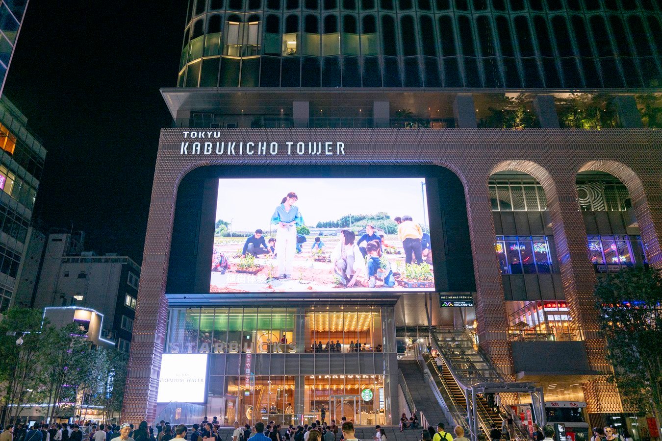 Night view of Tokyo's Kabukicho Tower bustling with tourists, highlighting vibrant nightlife on Japan tours.