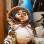 Traditional Tanuki figurine in Japan izakaya, perfect for a cultural tour experience. Discover Japan's unique charm.