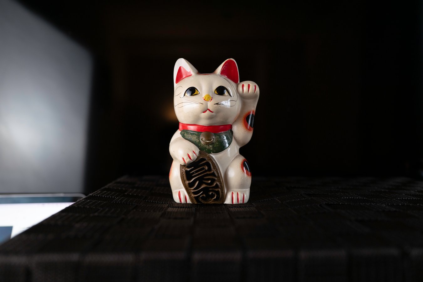 Lucky Maneki Neko cat beckoning prosperity on a Japan tour. Perfect for travel enthusiasts seeking cultural experiences.