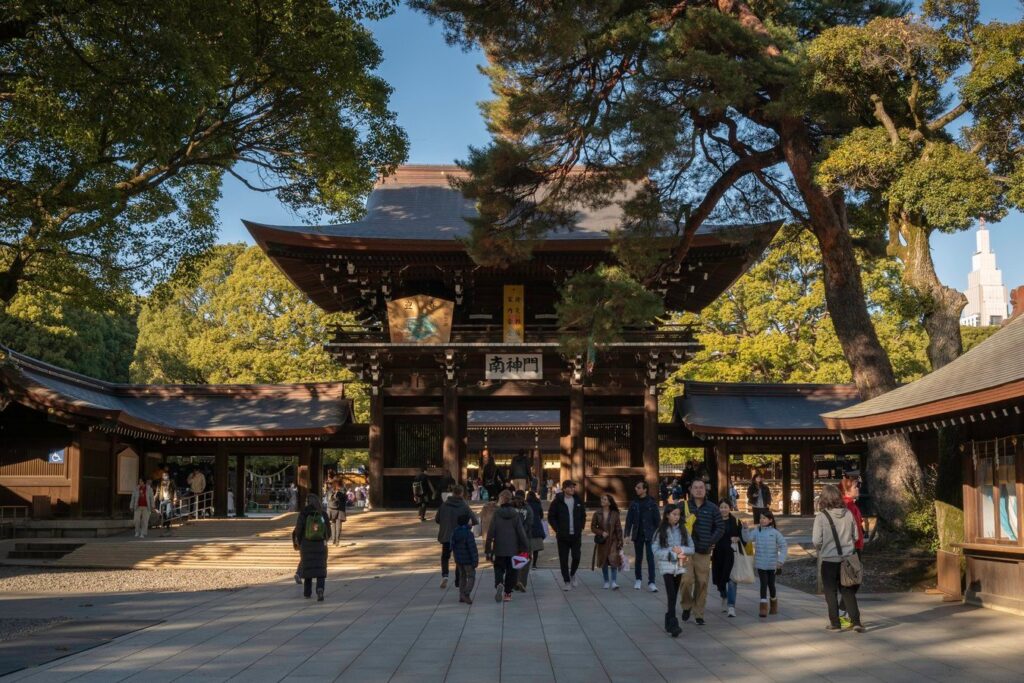 Visitors at a traditional Japanese temple gate, exploring cultural heritage in Japan's scenic landscapes.
