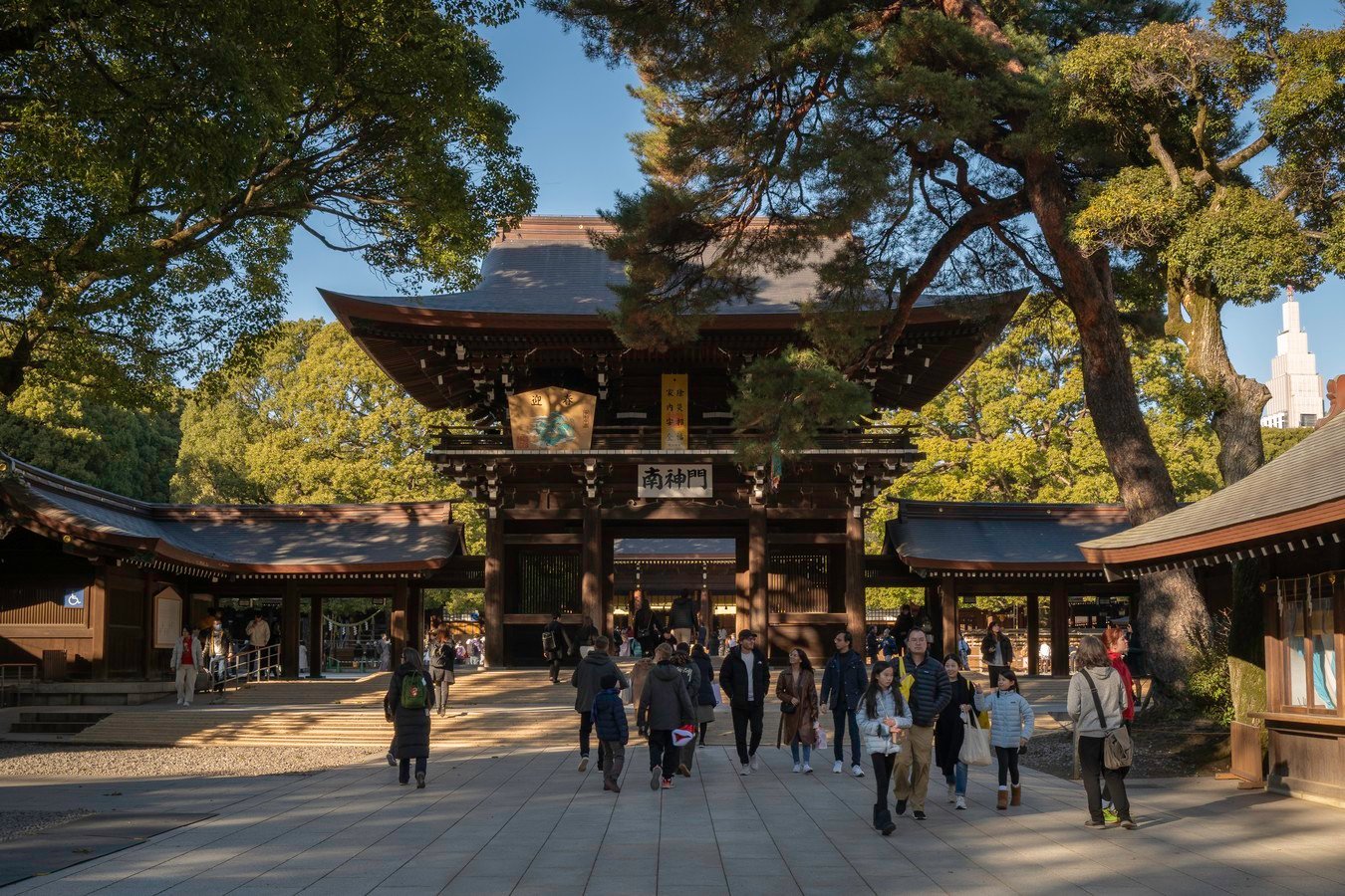 Visitors at a traditional Japanese temple gate, exploring cultural heritage in Japan's scenic landscapes.