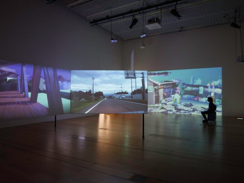 Immersive digital exhibition during a Japan tour, featuring scenic landscapes and modern art projections.