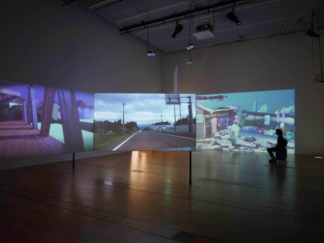 Immersive digital exhibition during a Japan tour, featuring scenic landscapes and modern art projections.