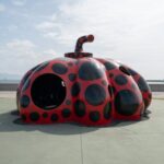 Iconic red pumpkin sculpture on Naoshima Island, a must-see on Japan art tours.