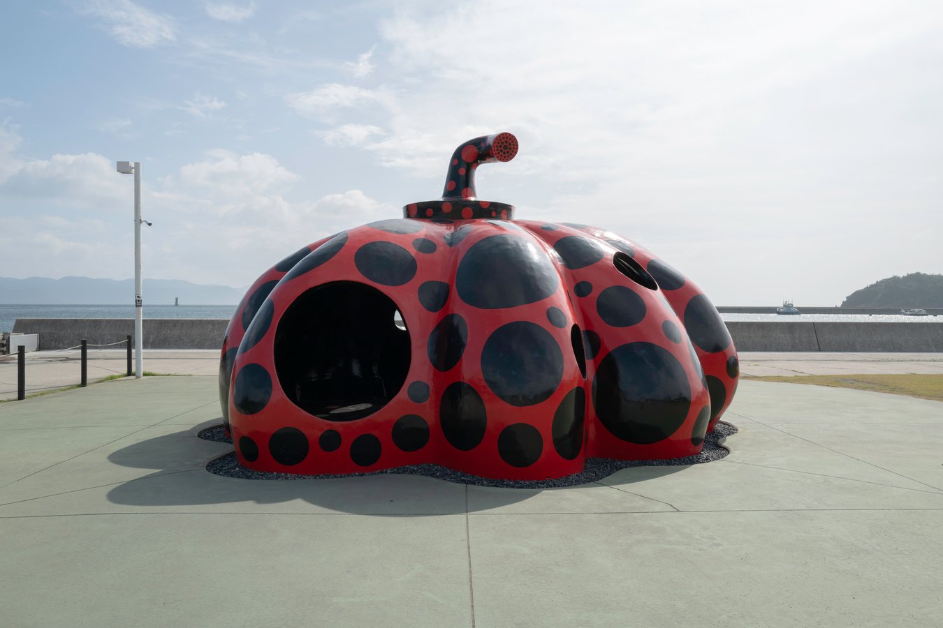Iconic red pumpkin sculpture on Naoshima Island, a must-see on Japan art tours.