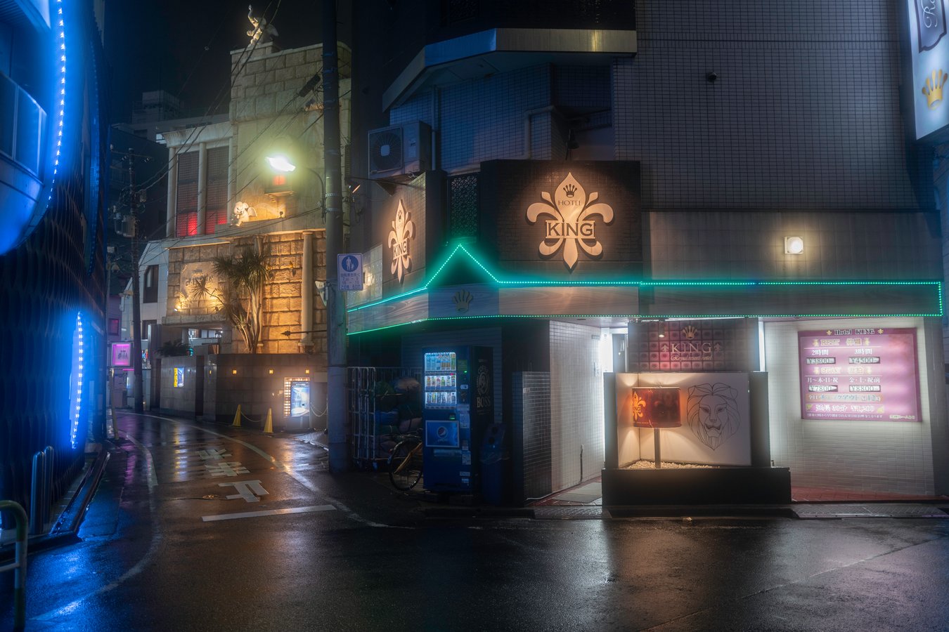 Moody night street view in Japan, featuring vibrant neon lights and urban architecture. Perfect for exploring Tokyo nightlife.