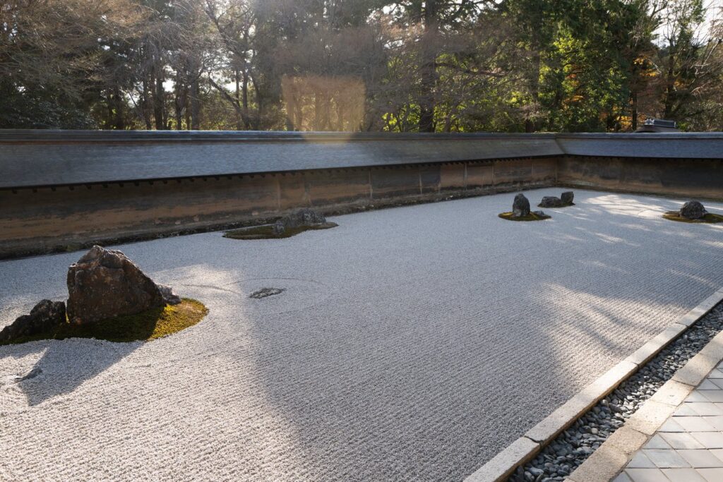 Zen rock garden at Ryoan-ji Temple in Kyoto, Japan, offers serene beauty on Japan tours.