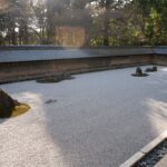 Zen rock garden at Ryoan-ji Temple in Kyoto, Japan, offers serene beauty on Japan tours.