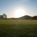 Sunset over Moerenuma Park's glass pyramid in Sapporo, Japan. Discover serene landscapes on your Japan tour.