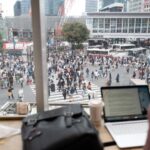 Bustling Shibuya Crossing in Tokyo, viewed from a café window, epitomizing the vibrant Japan city life.