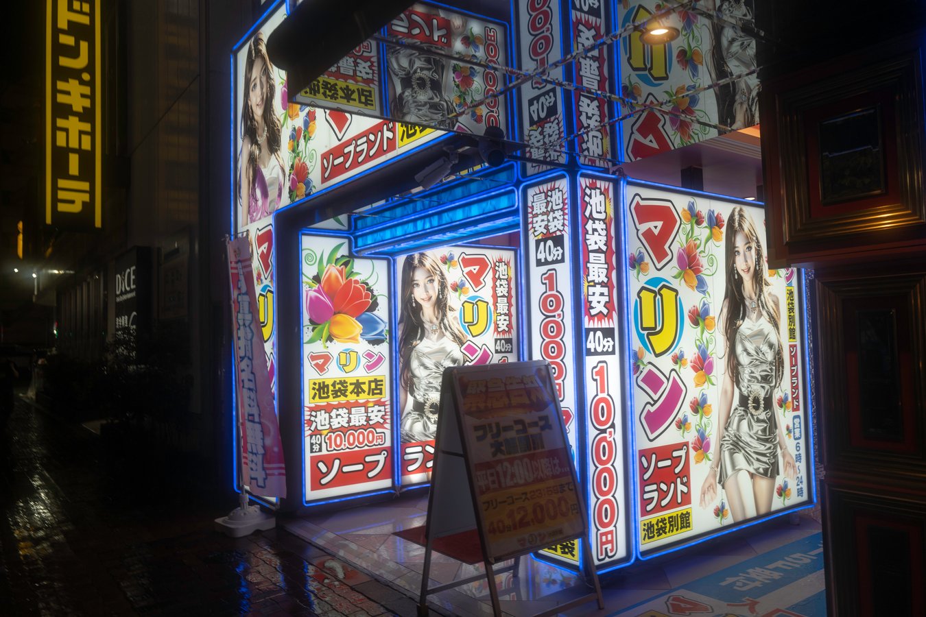 Brightly lit street in Tokyo with colorful signs, showcasing vibrant nightlife on a Japan tour.