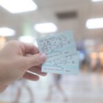 Hand holding Japan train tickets, ideal for exploring scenic rail routes on Japan tours.