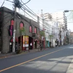 Japanese street scene with shops and vibrant signs, perfect for exploring on a Japan tour.